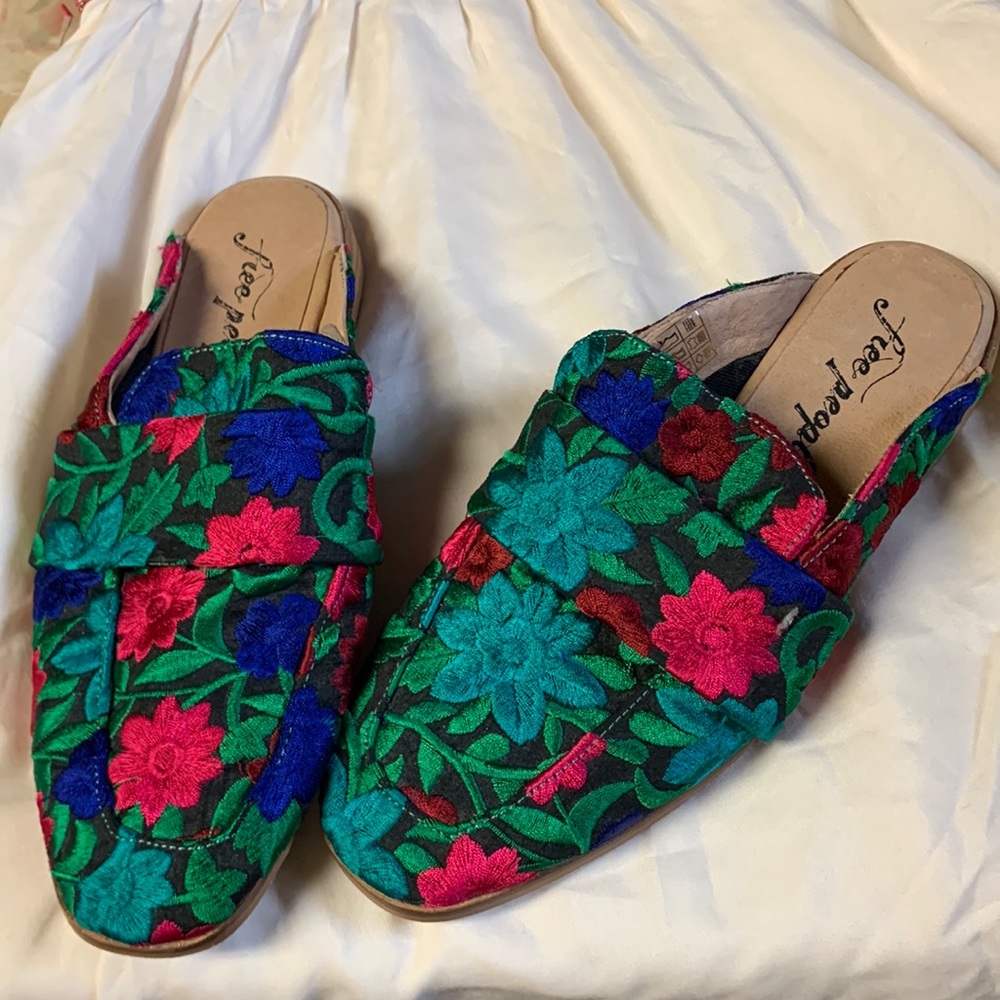 Free People embroidered flat mules.